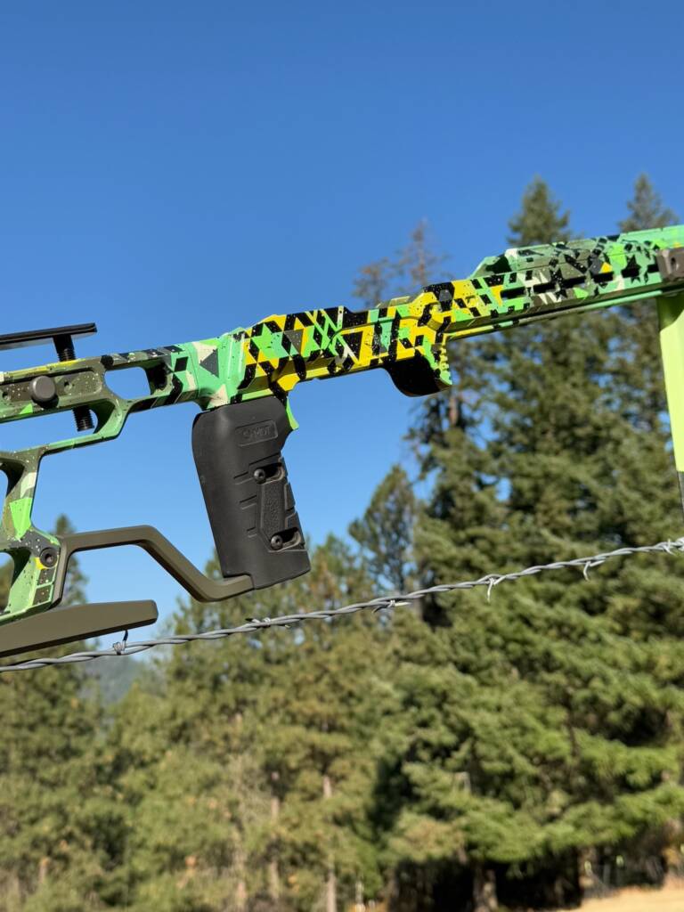 Rifle chassis with a green and black camo Cerakote finish